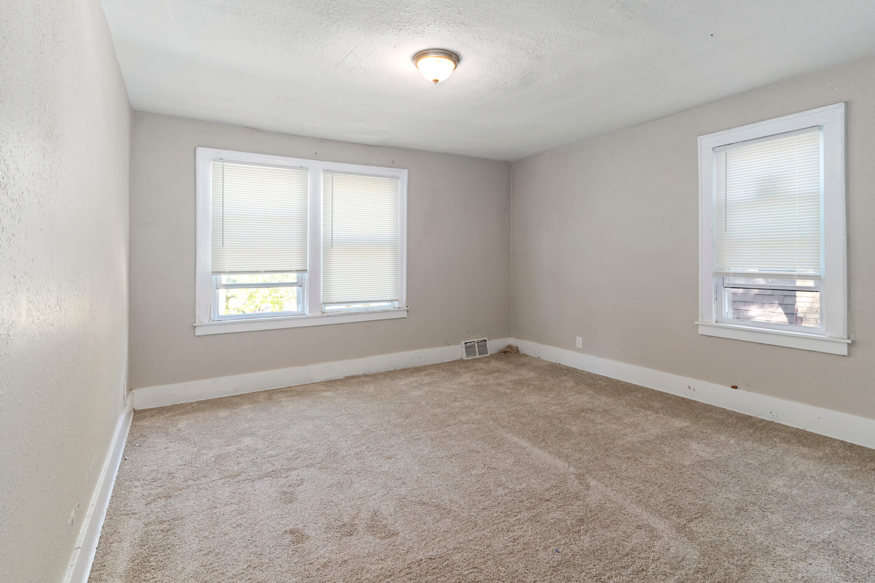 Tall slender porcelain bottle with natural clay textured body and cork stopper.